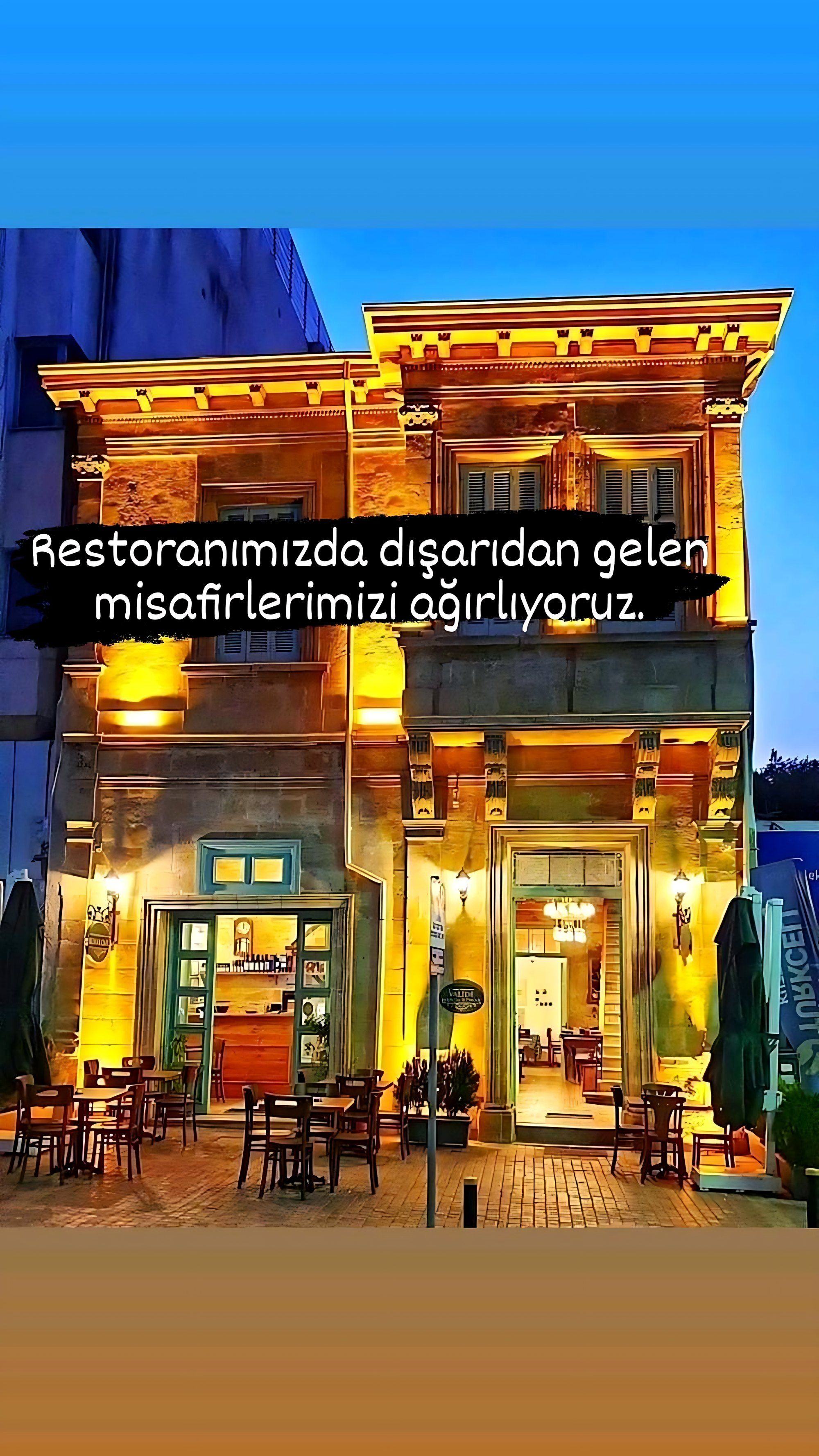 The konak’s façade lit up at night on Girne Caddesi