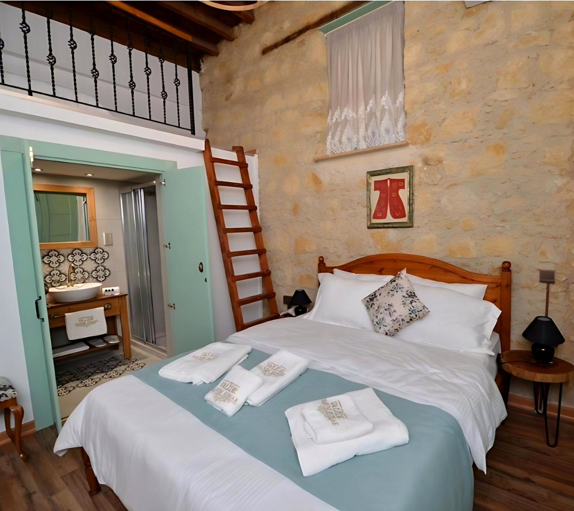 Room with a loft and a teal bathroom door